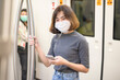 © tonefotografia - Young woman is wearing protective mask in metro , covid-19 protection , safety travel , new normal , social distancing , safety transportation , travel under pandemic concept .