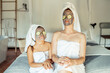 © Javier Sanchez Mingorance/Westend61 - Mother and daughter in towel with facial mask and slice of cucumber on eyes sitting at home