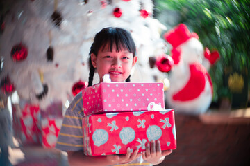 Asian daughter holding a gift box in christmas day