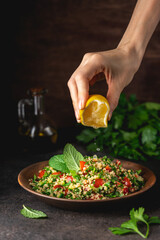 Wall Mural - Quinoa salad with parsley, cucumber and cherry tomatoes. Tabbouleh Traditional middle eastern or arab dish