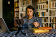 © VALENTINA BARRETO STUDIO/Westend61 - Boy vlogging with smart phone at table in living room