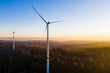© Werner Dieterich/Westend61 - Wind turbines standing in autumn forest at dusk