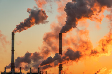 aerial view of high smoke stack with smoke emission. plant pipes pollute atmosphere. industrial fact
