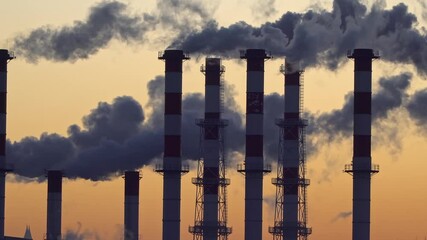 Wall Mural - industrial landscape, the pipes of the thermal power plant at sunset