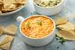 © fahrwasser - Buffalo chicken dip served with chips and fresh vegetables