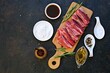 © Natallya_ph - Prepared ingredients for grilling pork ribs in sweet and sour glaze on a wooden board on a black concrete background. Ribs recipes
