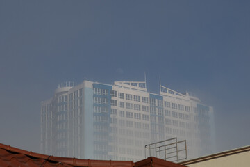 White and blue multi-storey building in blue sky background