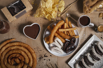 Canvas Print - Variety of traditional churros with granulated sugar and chocolate on a craft paper background.