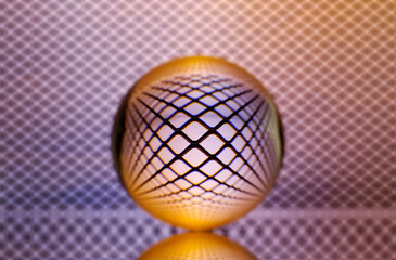 Closeup shot of a crystal ball with the reflection of the net in the background