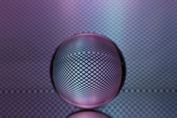 Closeup shot of a crystal ball with the reflection of the net in the background