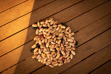 Top View Of Dry Pinto Beans On Wooden Background