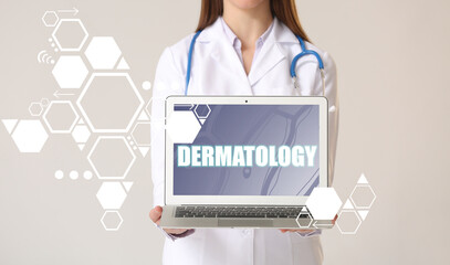 Wall Mural - Dermatologist with laptop on light background. Concept of telemedicine