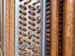 Close up shot of copper plain tubes of a condenser coil.	
