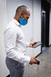 © Wavebreak Media - Mixed race man wearing face mask in an office