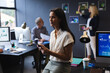 © Wavebreak Media - Mixed race businesswoman sitting on desk using digital tablet in creative office