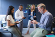 © Wavebreak Media - Diverse men and women working in office, writing, using laptop