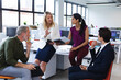 © Wavebreak Media - Group of diverse business people brainstorming in modern office