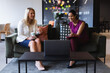 © Wavebreak Media - Diverse businesswomen having coffee using laptop during video call in creative office