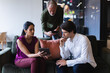 © Wavebreak Media - Diverse businessman and businesswoman wearing using electronic devices in office