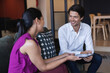 © Wavebreak Media - Smiling diverse businessman and businesswoman using tablet talking in creative office
