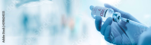 Fototapeta na szkło doctor in medical gloves with a syringe in his hands .Vaccine Concept of fight against coronavirus