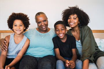 Grandmother, mother and children together at home.