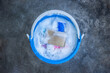 © blove - Dishwashing liquid in a blue plastic bucket with plastic cups, sponge on Cement floor. Prepare to wash