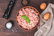 Raw minced meat in bowl on wooden table