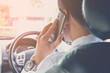 Hand using phone sending a text while driving to work ,businessman