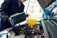 Changing Engine Oil At Car Service Station