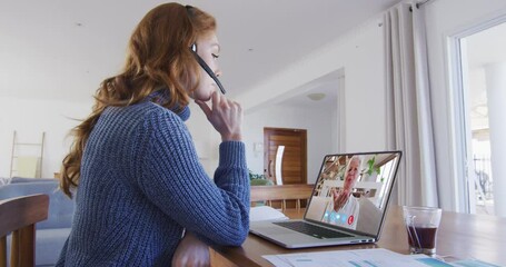 Poster - Caucasian woman on laptop video chat wearing phone headset at home