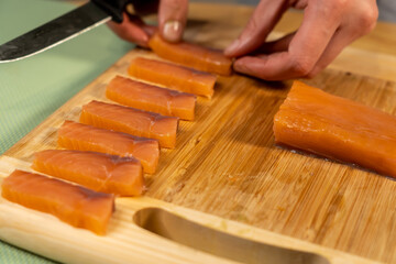 Sticker - Closeup shot of a person cutting salmon for sushi