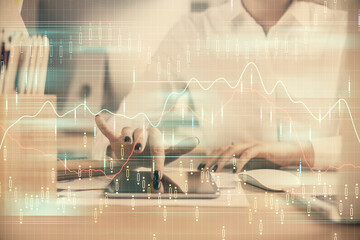 Double exposure of forex chart sketch hologram and woman holding and using a mobile device. Financial market concept.