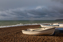 A View Of Seaford Beach, With Boats Moored On The Pebbles