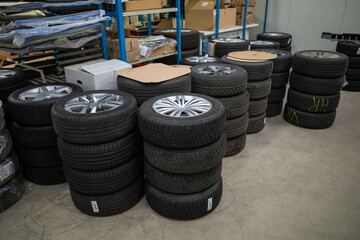 in car workshop there are many stacked car tires