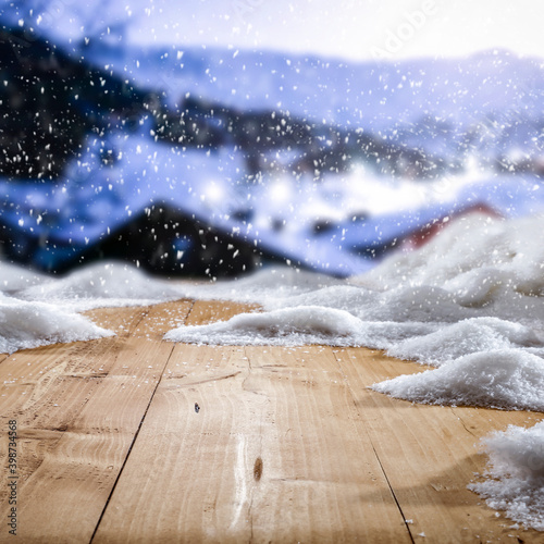 Fotografie, Obraz Fresh snow on a wooden table with an alpine view of the mountains