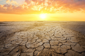 dry cracked earth at the dramatic sunset, ecologigal calamity background