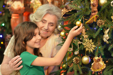 Sticker - Smiling little girl with grandmother on Christmas