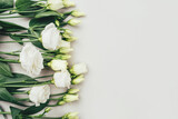 Fototapeta Tulipany - Fresh white flowers on a grey pastel background. Spring or summer minimal concept. Copy space for text.