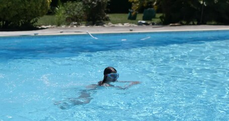 Wall Mural - pretty young girl diving into the swimming pool