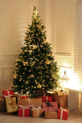 Wall Mural - Gift boxes under Christmas tree with fairy lights indoors