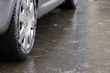 Ice crusted ground, car wheel on icy road, hazardous weather conditions