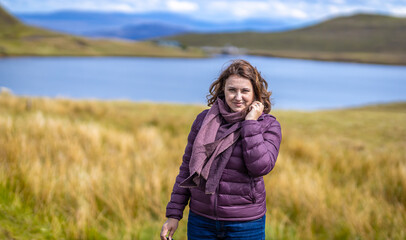 Wall Mural - Lady at Isle of Skye, known for its rugged landscapes, picturesque fishing villages and medieval castles