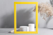 Geometric podium scene with Dry reed and yellow frame on paper ultimate gray background