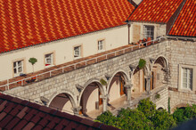 A Building With Arches And Red Roofs