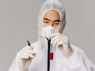 male laboratory assistant protective medical clothing research science gray background