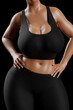 © PixlMakr - Young slim woman with big breasts in black sportswear