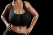© PixlMakr - Young slim woman with big breasts in black sportswear