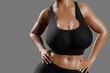 © PixlMakr - Young slim woman with big breasts in black sportswear