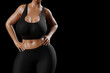 © PixlMakr - Young slim woman with big breasts in black sportswear